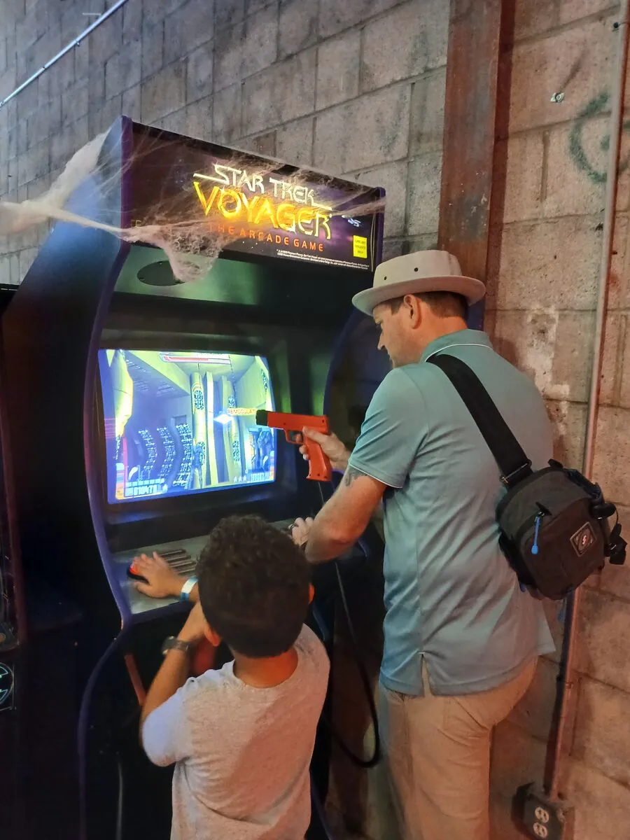 Jared and Levi playing the Star Trek Voyager arcade game with a light gun