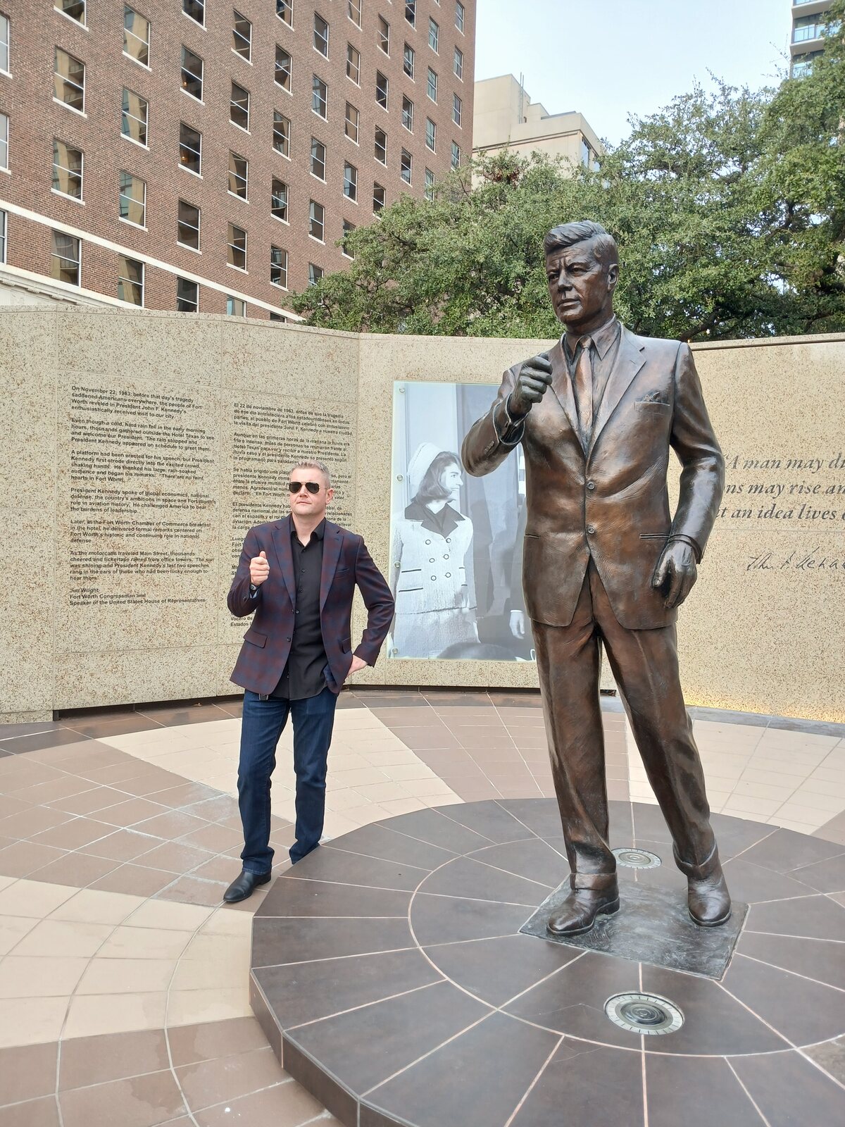 Jared Alan Stewart mirroring the JFK statue's pose at the Fort Worth JFK Tribute
